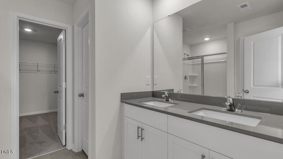 1248 Pavo Path Wendell, NC 27591 - Photo 24 of 46 a bathroom with double sink and a mirror