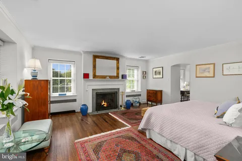 a bedroom with a bed and a fireplace