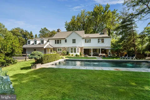 a front view of a house with a yard table and chairs