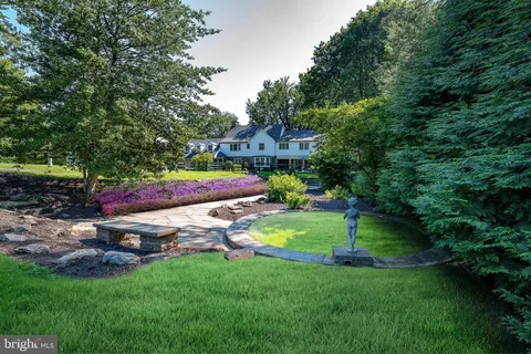 a view of backyard with swimming pool and green space
