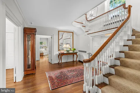 a view of entryway dining room and hall with wooden floor