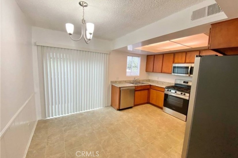 4237 Dixie Canyon Avenue, Unit 2 Sherman Oaks, CA 91423 - Photo 2 of 9 a kitchen with stainless steel appliances granite countertop a stove and a refrigerator