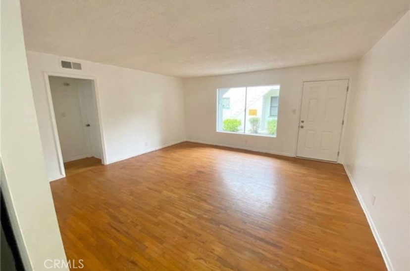 4237 Dixie Canyon Avenue, Unit 2 Sherman Oaks, CA 91423 - Photo 4 of 9 a view of empty room with wooden floor and fan
