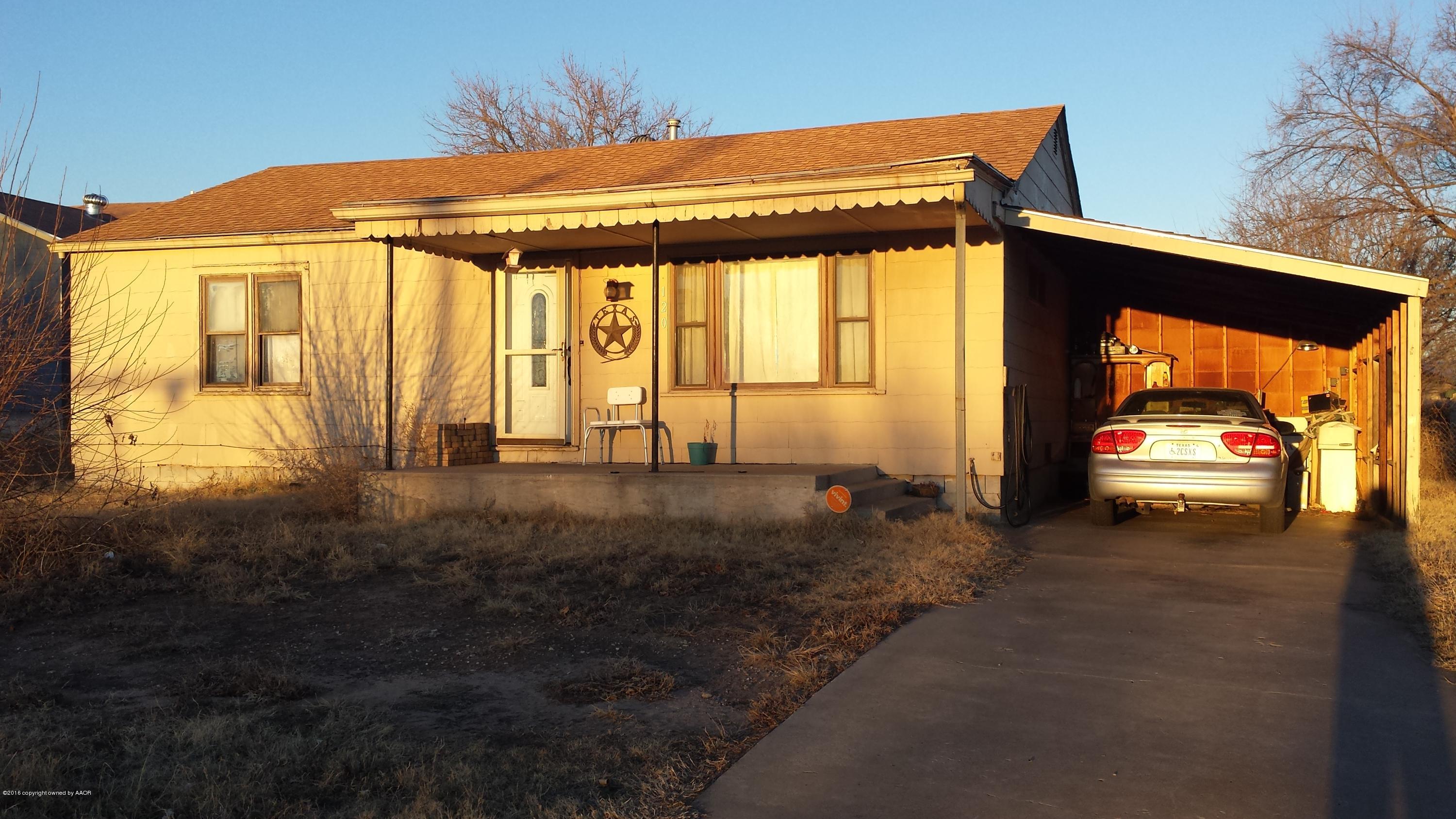 a view of a car park in front of a house