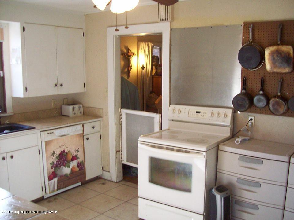 120 Elm Street Borger, TX 79007 - Photo 8 of 13 a kitchen with a stove and cabinets