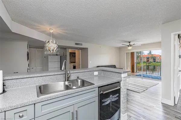a room with pool table and windows