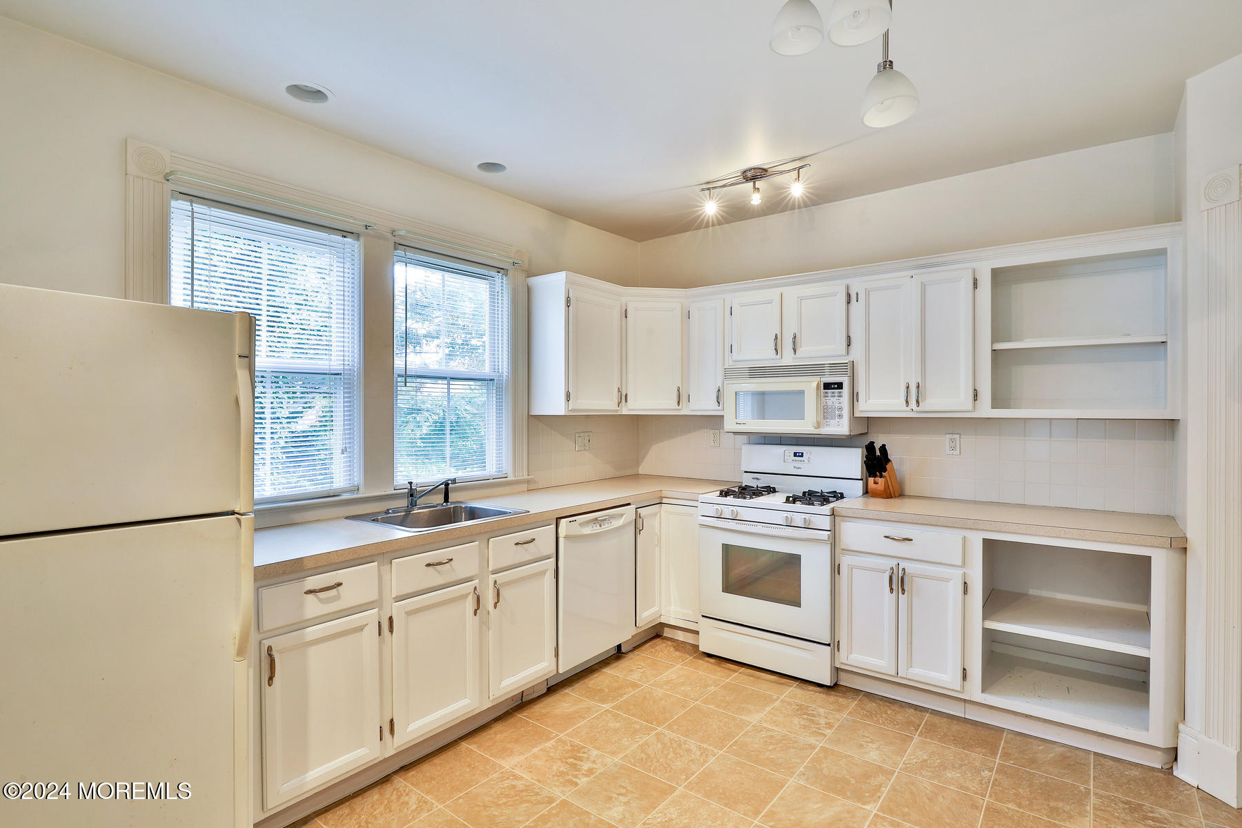 94 Branch Avenue Red Bank, NJ 07701 - Photo 5 of 21 a kitchen with white cabinets and white appliances