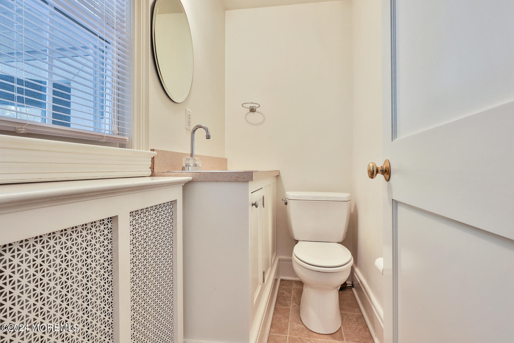 94 Branch Avenue Red Bank, NJ 07701 - Photo 7 of 21 a bathroom with a sink a toilet and a mirror