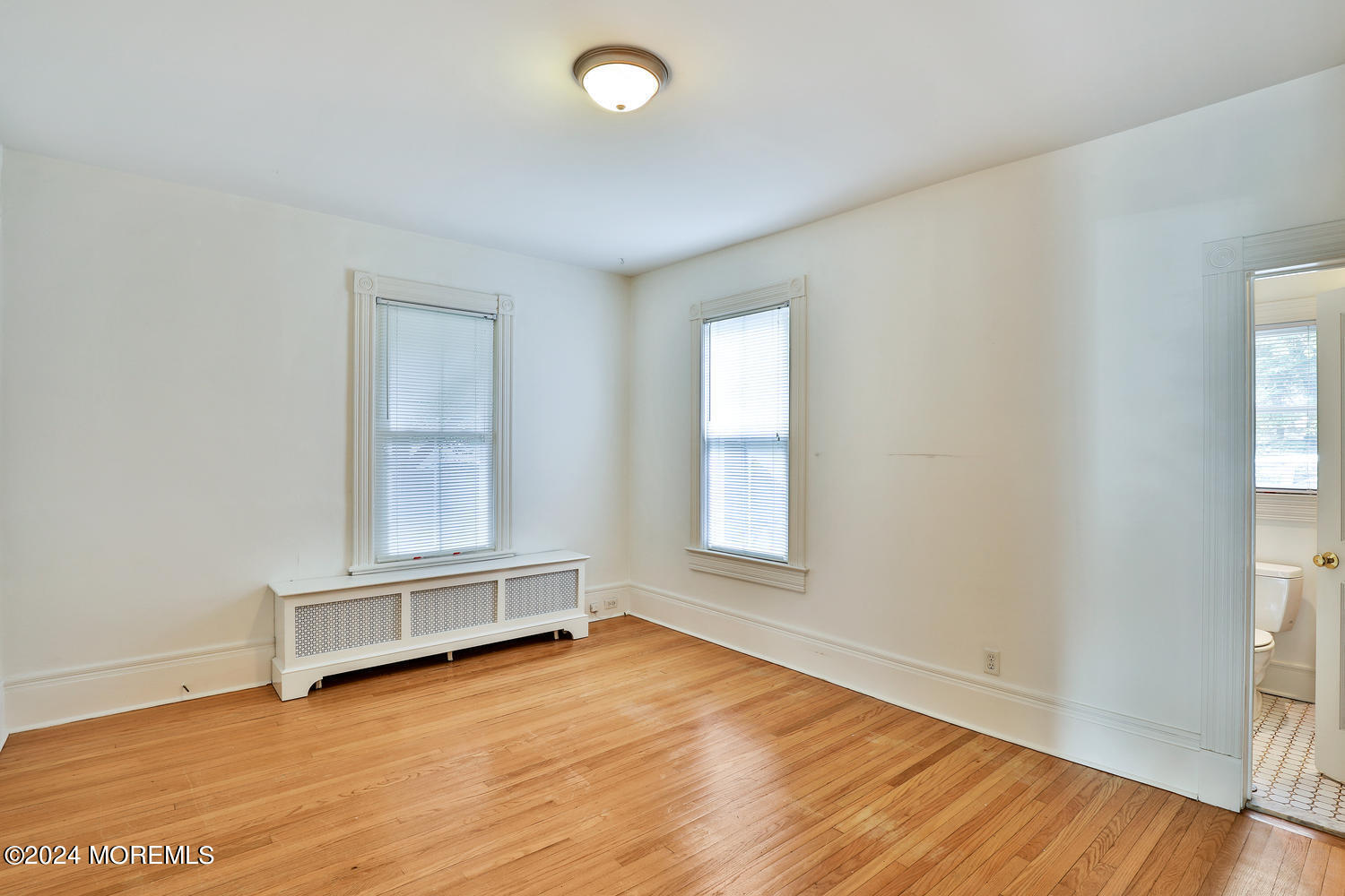 94 Branch Avenue Red Bank, NJ 07701 - Photo 8 of 21 an empty room with wooden floor and windows
