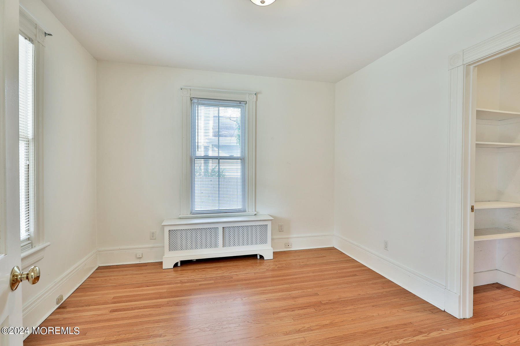 94 Branch Avenue Red Bank, NJ 07701 - Photo 10 of 21 a view of an empty room with wooden floor and a window