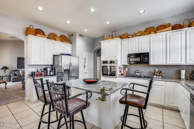 a spacious bedroom with a bed and a chandelier