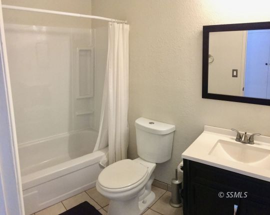 509 South Helena Street Ridgecrest, CA 93555 - Photo 13 of 40 a bathroom with a sink and a toilet