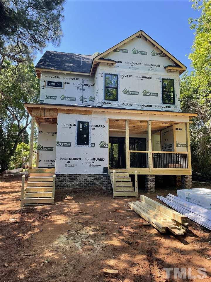 713 Mial Street Raleigh, NC 27608 - Photo 7 of 27 Grand Living Room w/ Built-in Cabinets, Masonry Fireplace + Shiplap accent walls. Screened Porch doors are Double Slider