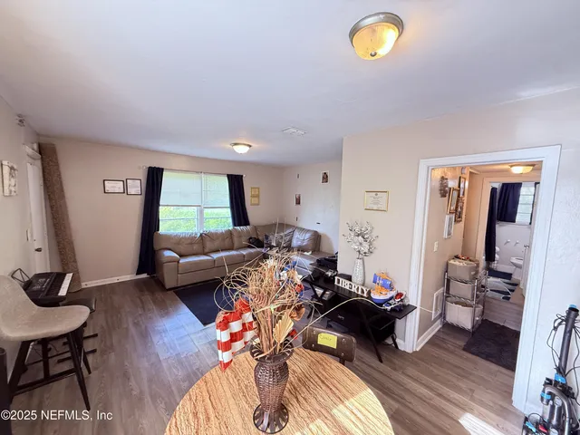 a living room with furniture and a wooden floor