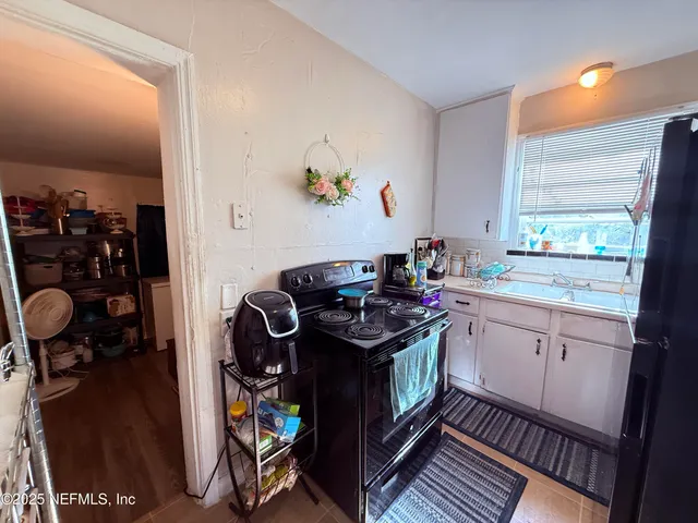 a kitchen with a stove and a sink