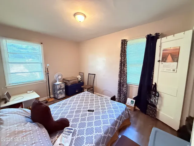 a bedroom with a bed and a chair