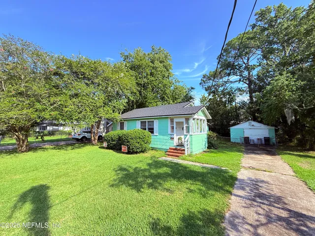 a view of a house with a yard porch and sitting area