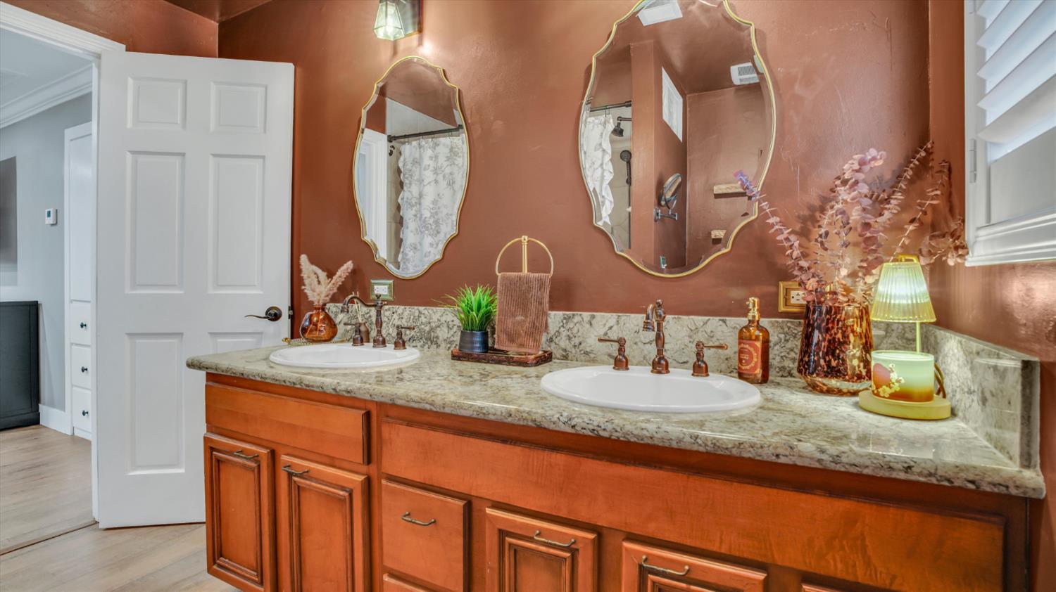 2331 East Woodson Road Acampo, CA 95220 - Photo 19 of 59 a bathroom with double vanity sinks and a mirror