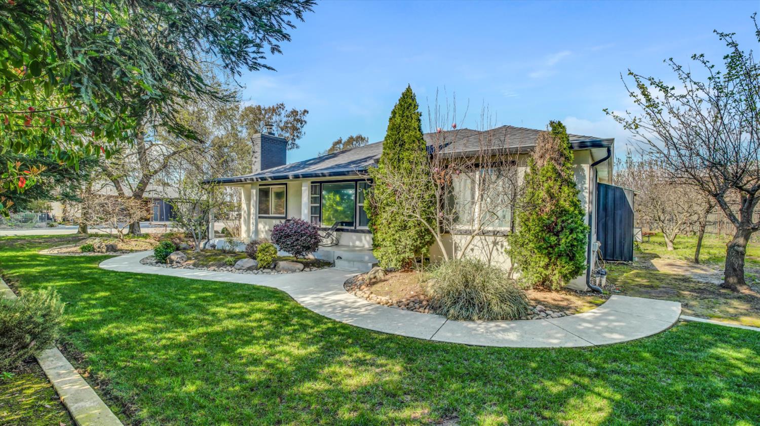 2331 East Woodson Road Acampo, CA 95220 - Photo 2 of 59 a view of a house with a backyard porch and sitting area