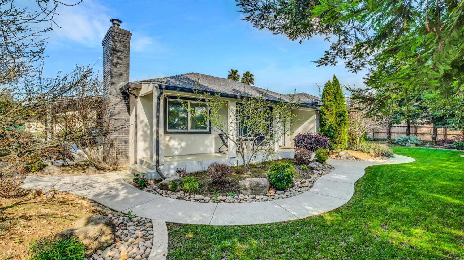 2331 East Woodson Road Acampo, CA 95220 - Photo 4 of 59 a front view of a house with garden