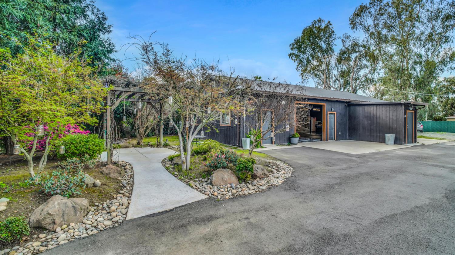 2331 East Woodson Road Acampo, CA 95220 - Photo 42 of 59 a view of a house with a yard and potted plants