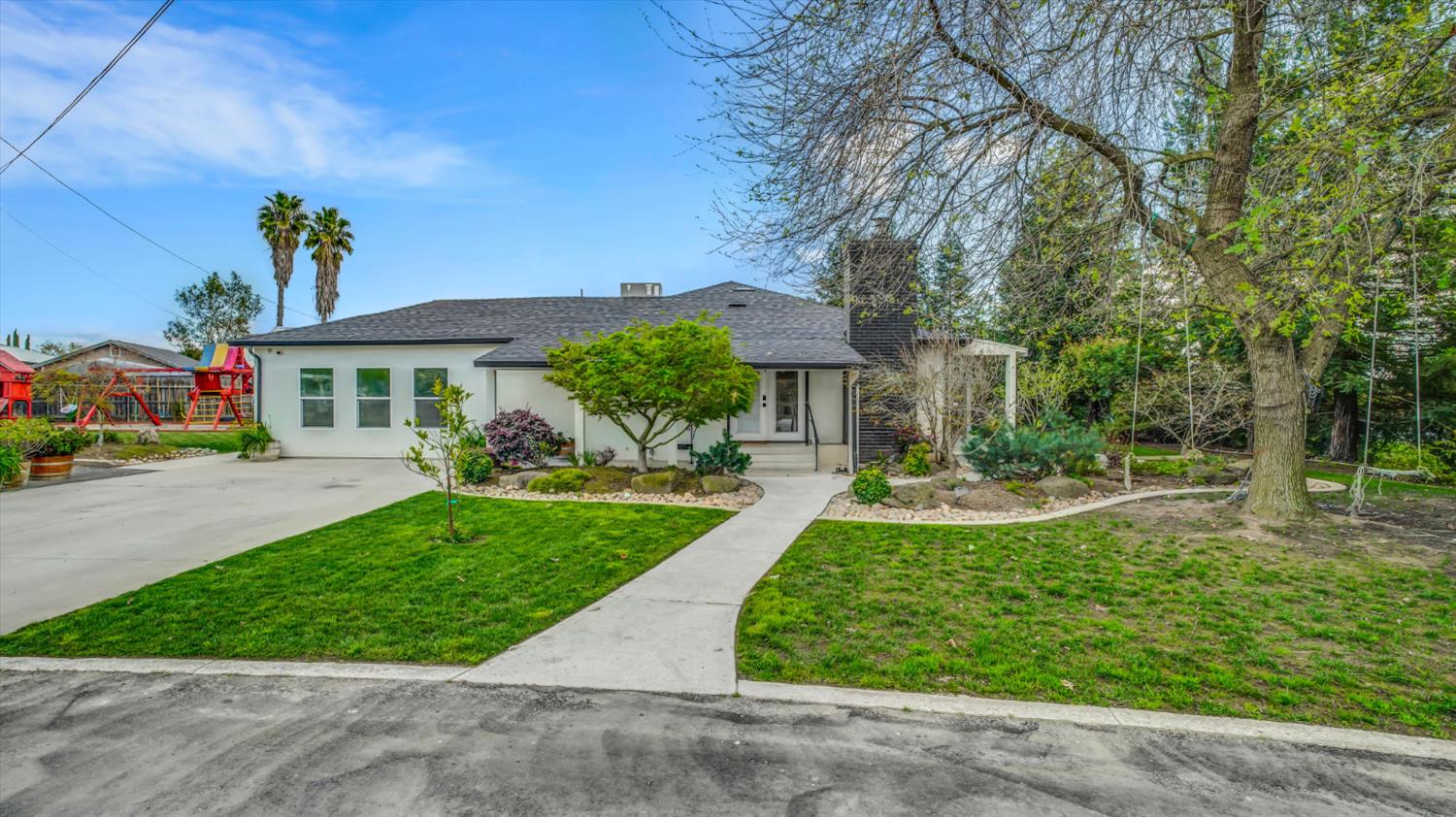 2331 East Woodson Road Acampo, CA 95220 - Photo 5 of 59 a front view of a house with a yard