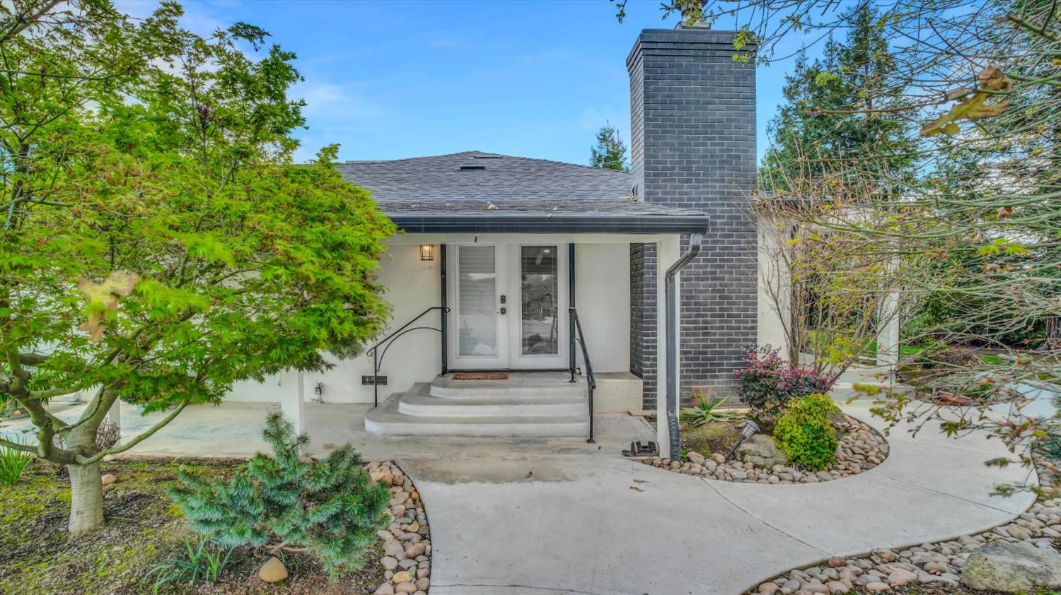 2331 East Woodson Road Acampo, CA 95220 - Photo 7 of 59 a front view of a house with a garden