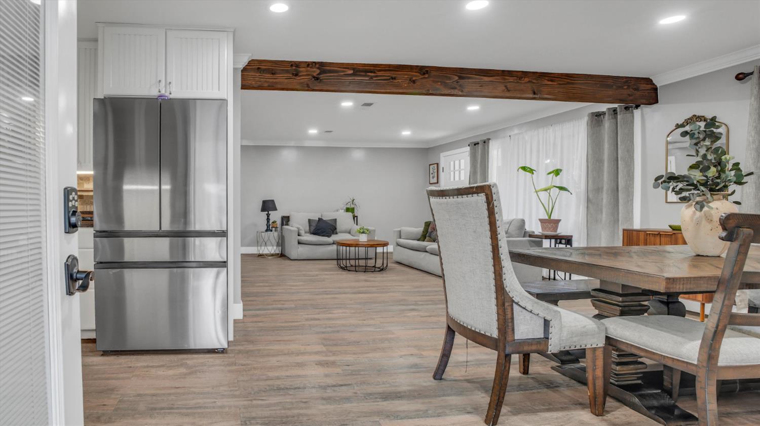2331 East Woodson Road Acampo, CA 95220 - Photo 8 of 59 a kitchen with stainless steel appliances refrigerator dining table and chairs