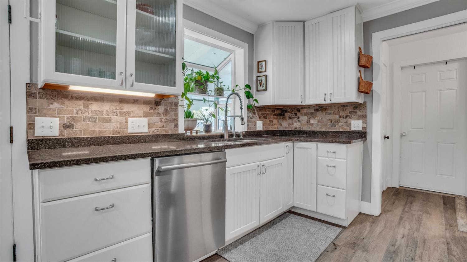 2331 East Woodson Road Acampo, CA 95220 - Photo 9 of 59 a kitchen with granite countertop white cabinets and white appliances