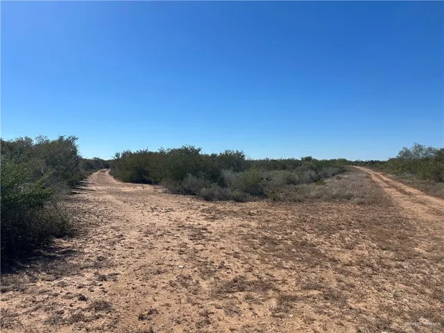 a view of dirt road with a city view