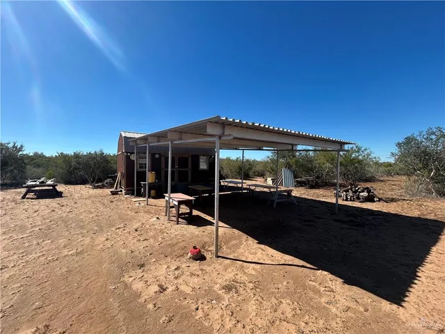 a view of a house with backyard porch and sitting area
