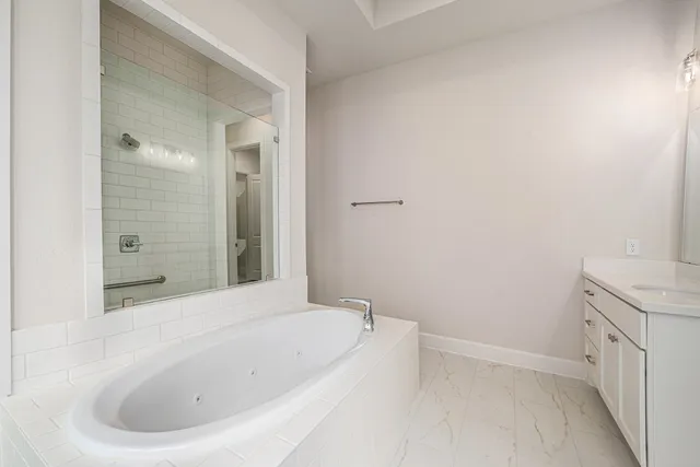 a bathroom with a bathtub and a sink