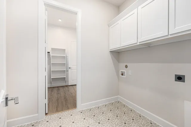a view of storage and utility room with wooden floor
