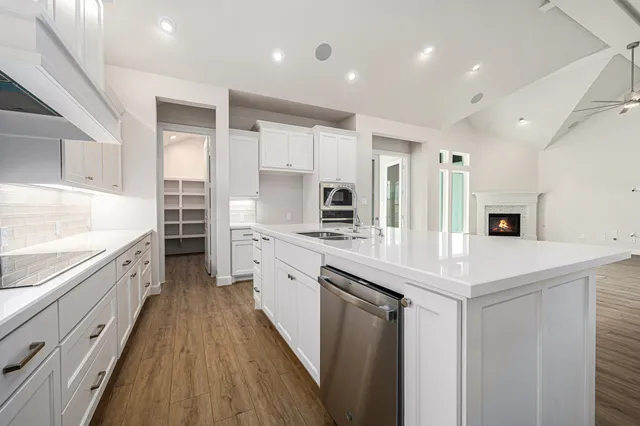 a kitchen with stainless steel appliances sink refrigerator and microwave