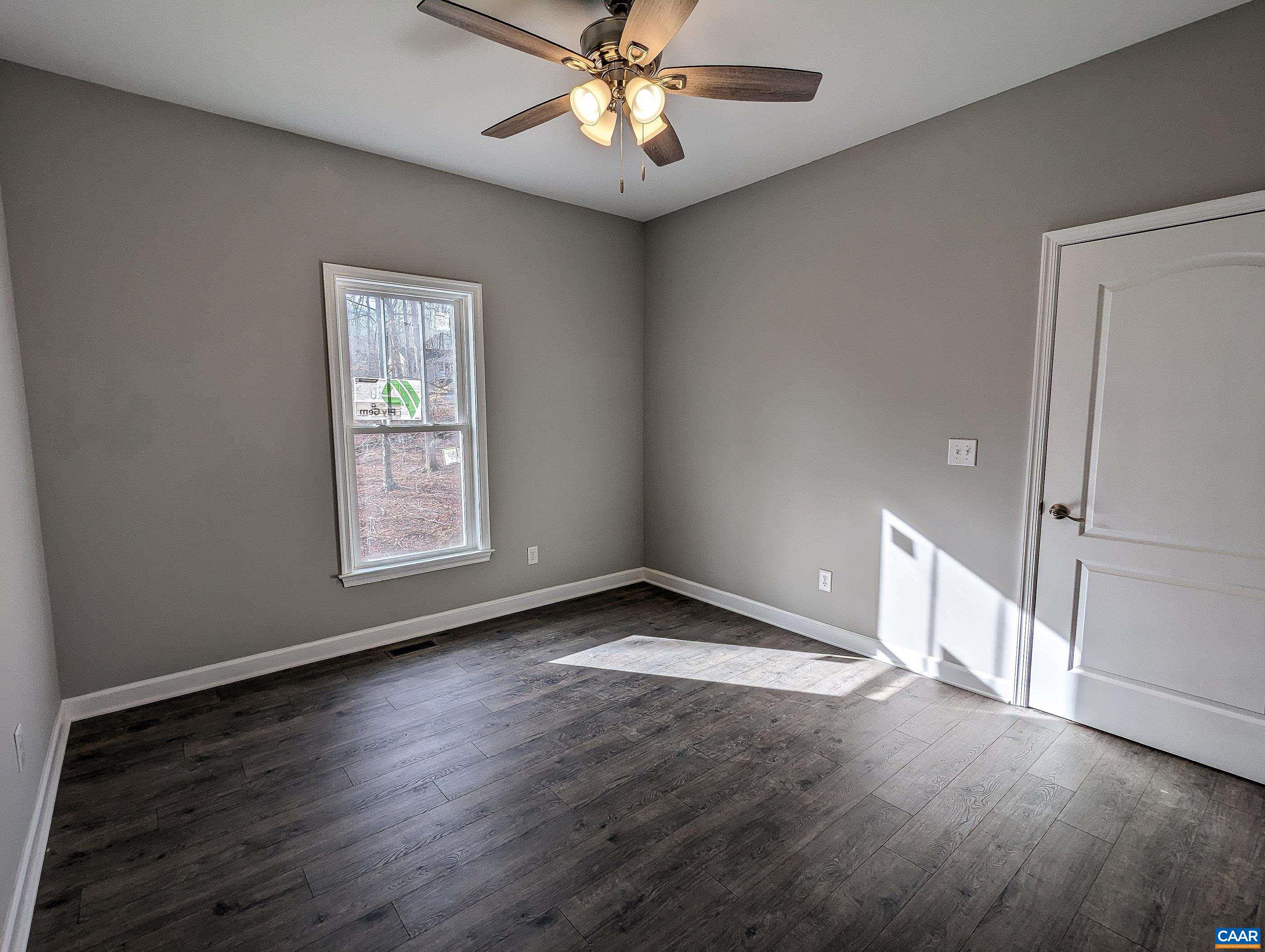 13 Amethyst Road Palmyra, VA 22963 - Photo 21 of 39 an empty room with wooden floor chandelier fan and windows