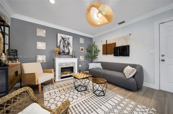 a living room with furniture a fireplace and a flat screen tv