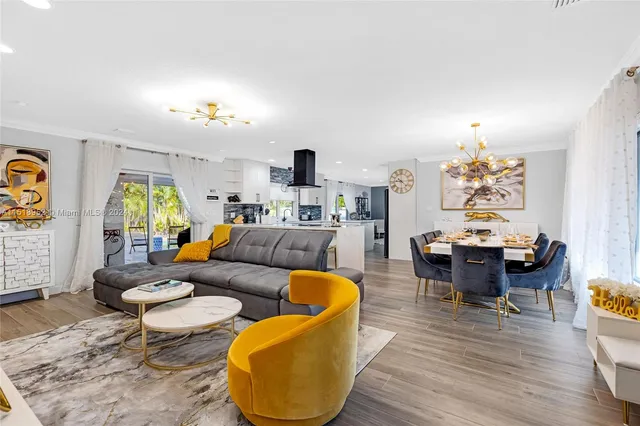 a living room with furniture a rug and a chandelier