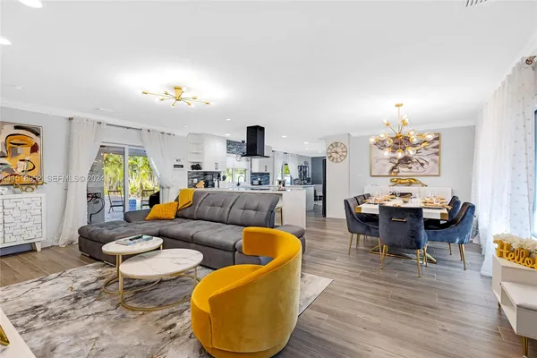 a living room with furniture a rug and a chandelier