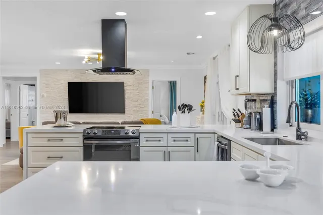 a kitchen with stainless steel appliances a stove microwave and cabinets