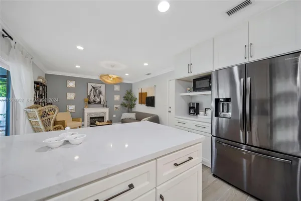 a kitchen with stainless steel appliances a refrigerator sink and microwave