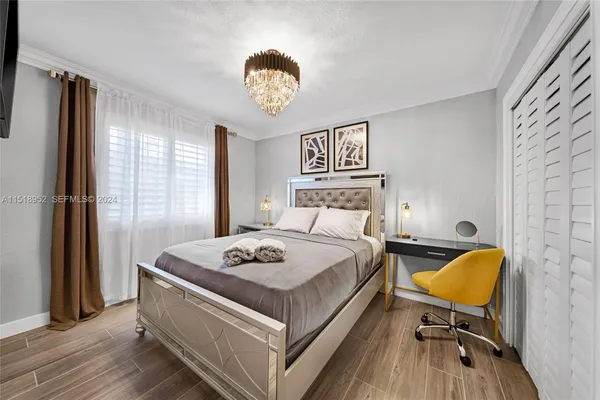 a bedroom with a bed and a chair in it