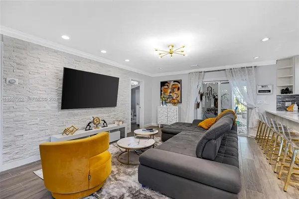a living room with furniture and a flat screen tv