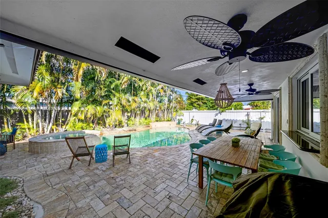 a view of a patio with a table chairs and a backyard