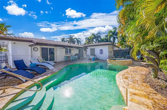 a view of a house with backyard porch and sitting area