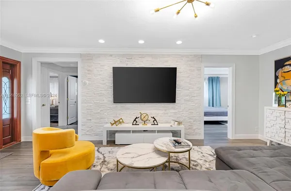 a living room with furniture and a flat screen tv