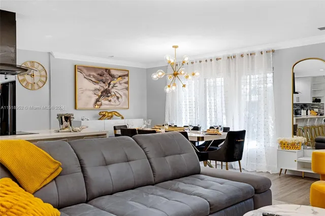 a living room with furniture and large windows