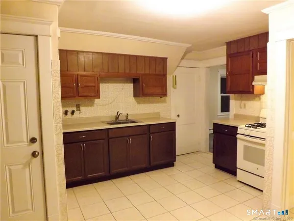 a spacious bathroom with a granite countertop sink and a mirror