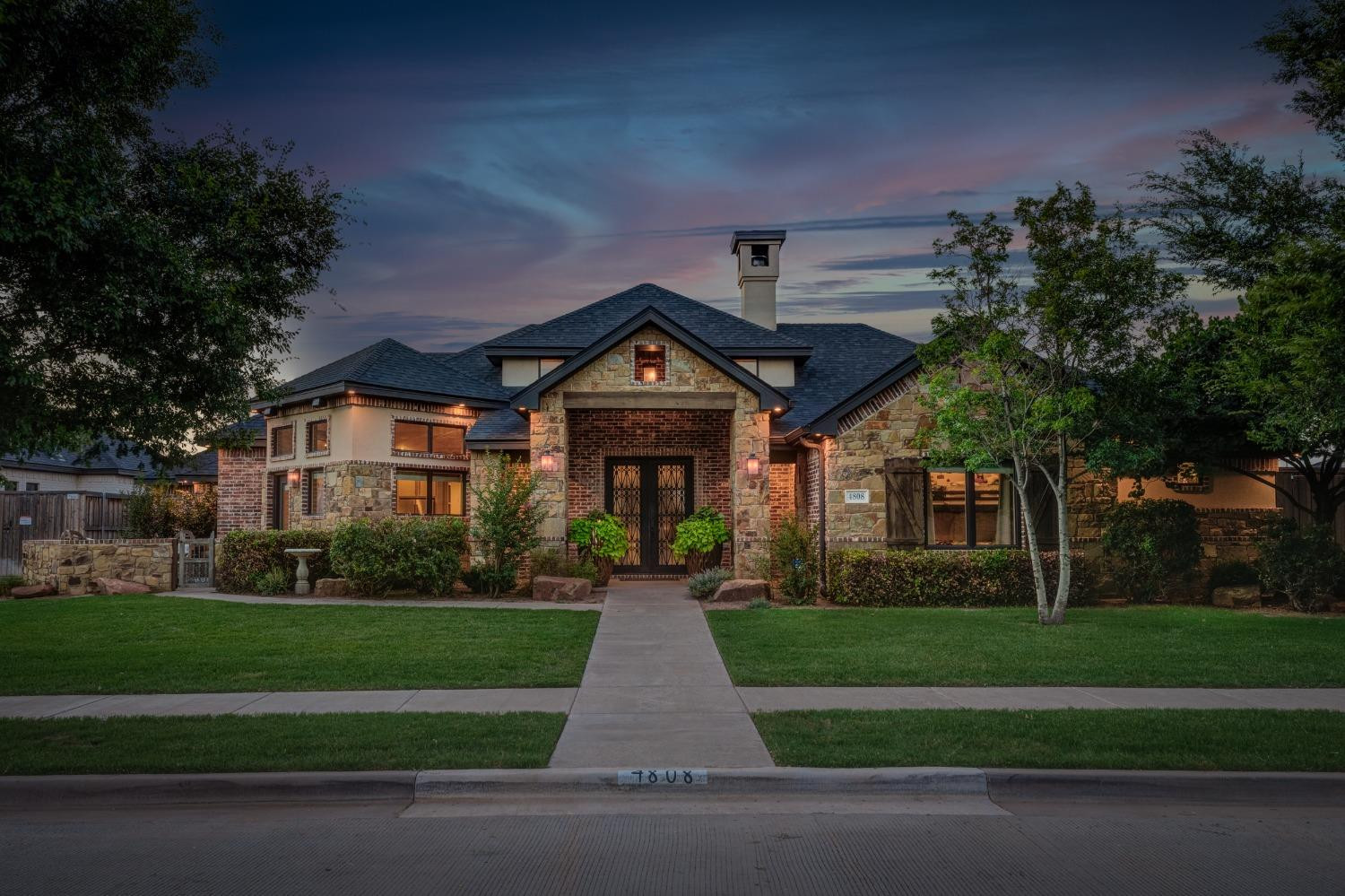 4808 115th Street Lubbock, TX 79424 - Photo 1 of 50 a front view of a house with a yard