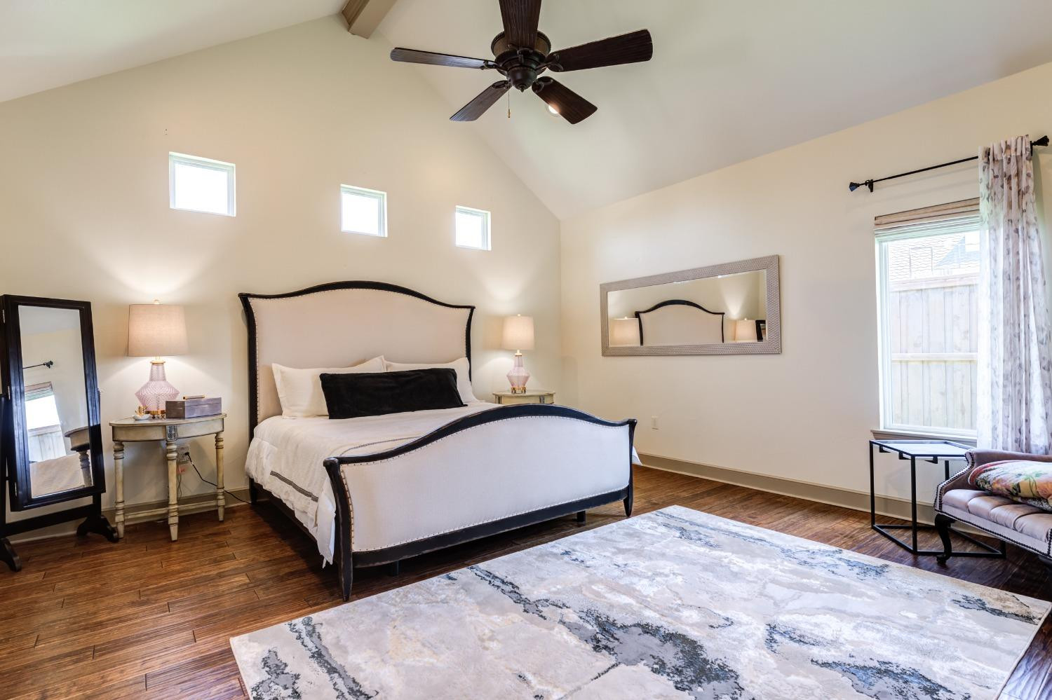4808 115th Street Lubbock, TX 79424 - Photo 17 of 50 a bedroom with a bed lamp and a window