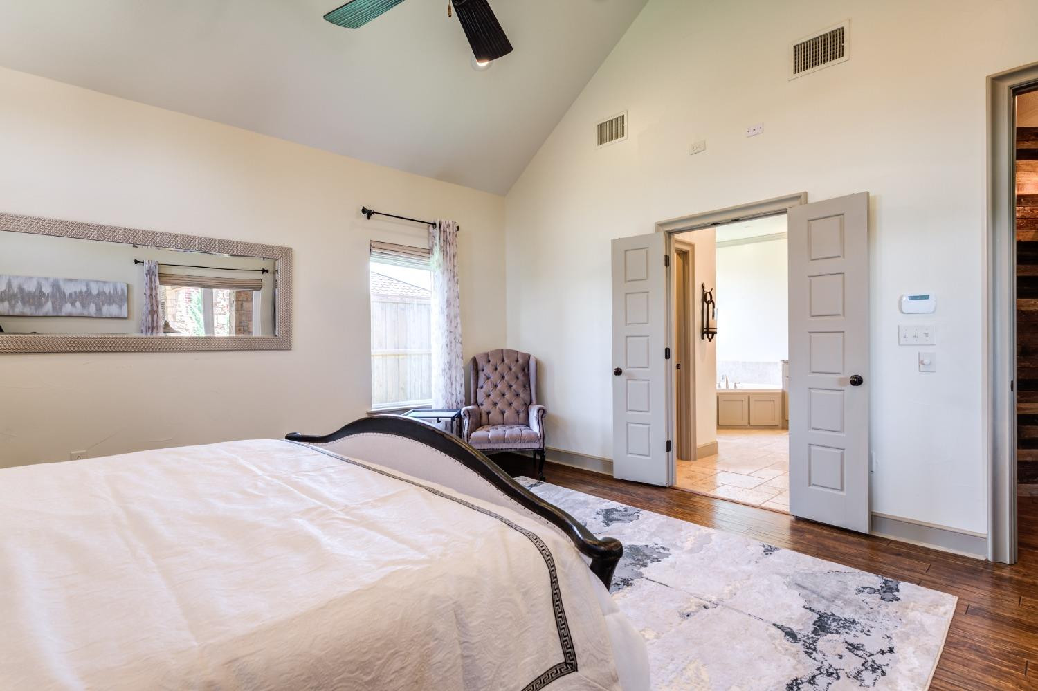 4808 115th Street Lubbock, TX 79424 - Photo 18 of 50 a bedroom with a bed and a chandelier